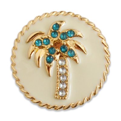 The Crest snap is a cream enamel palm tree with turquoise and clear stones on a gold base.