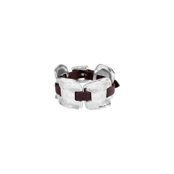 Bracelet in silver-plated metal alloy with leather strips interwoven.  Adjustable buckle clasp.